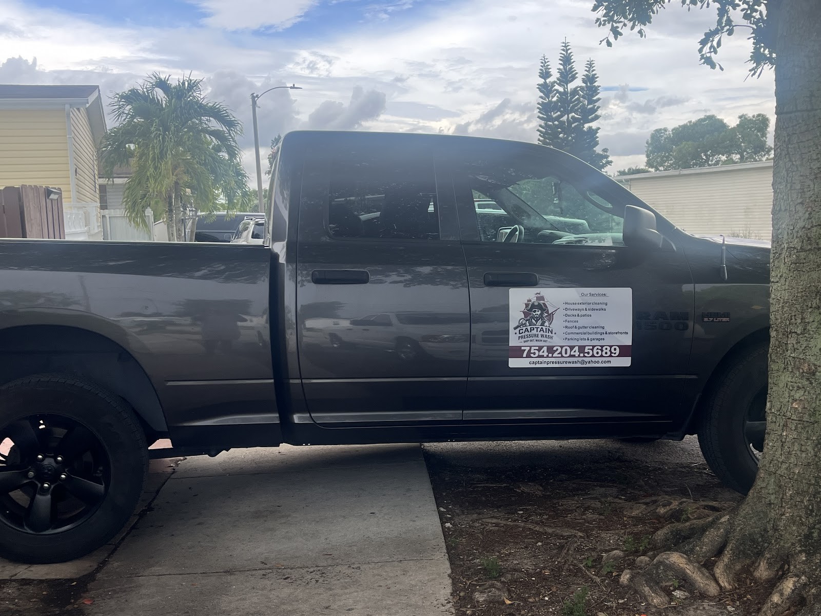 Captain Pressure Wash gray Ram 1500 truck with company magnet showing services and phone number